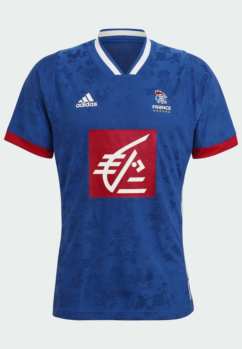 Blauw T-shirt met korte mouwen, voorzien van bloemenpatroon, witte V-hals, rode mouwen en een centraal rood logo. Heeft Adidas-branding op de schouders.