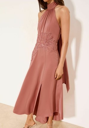 Rochie midi fără mâneci, de culoare roz prăfuit, cu guler înalt, broderie florală mare în talie, despicătură frontală și o panglică lungă din material în spate.