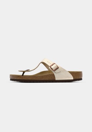 Brun kork sål flip-flop sandal med en beige ruskindsoverdel og et enkelt justerbart rem med en metalspænde. Flad såldesign.