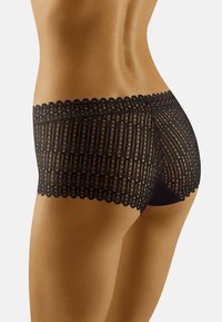 Shorts en dentelle noire mettant en valeur une taille scallopée et des motifs complexes, avec une finition en tissu lisse et une couverture partielle à l'arrière.