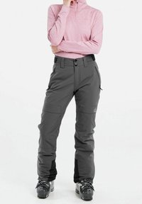 Skidbyxor i mörkgrått, tillverkade av vattentätt material. Med flera fickor, justerbar midja och en avslappnad passform för rörlighet.