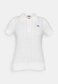 Polo shirt bianco a maglia cable knit con orlo a costine, maniche corte e collo a camicia. Presenta un logo nero sul lato sinistro.