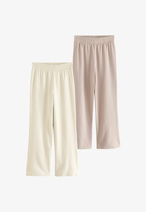 Zwei Paar cropped Hosen: eine in Off-White und eine in sanftem Beige. Beide haben einen elastischen Gummibund und eine glatte, dehnbare Stofftextur.