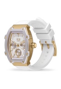 Reloj octagonal en tonos dorado y plateado con una correa de silicona blanca. Cuenta con tres subdiales y un dial texturizado en blanco.