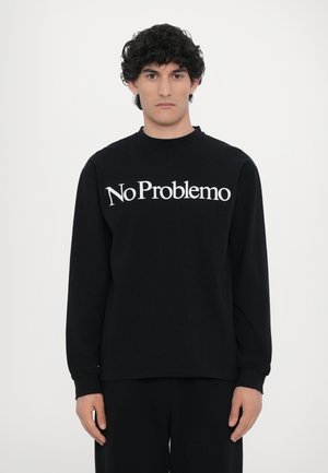 Black long-sleeve sweatshirt made of soft fabric, featuring white text "No Problemo" across the chest and a relaxed fit.