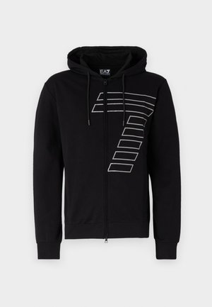 Black zip-up hoodie made of cotton, featuring a large white graphic pattern on the left side and drawstrings on the hood.