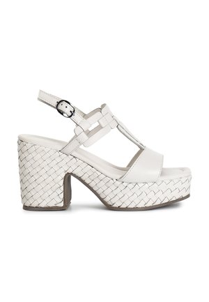 White platform sandals with woven textured heel, adjustable ankle strap, and T-bar design. Smooth material and padded footbed for comfort.