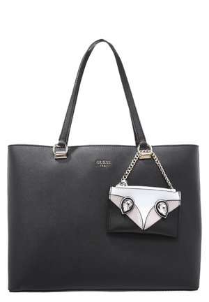 Black Guess tote bag with two shoulder straps and a small attached black, white, and pink envelope-style pouch with crystal embellishments.