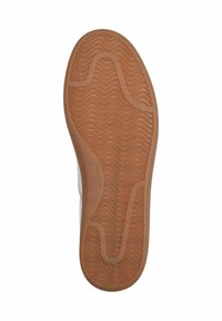 Semelle de chaussure en caoutchouc brun clair avec motif ondulé et rainures incurvées pour adhérence et flexibilité.