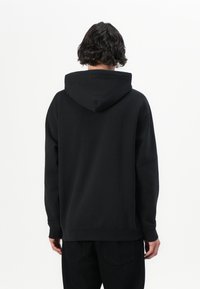 Sort hætte sweatshirt med en afslappet pasform, der har en blød tekstur, kengurulomme og ribbede manchetter ved ærmeslutterne.