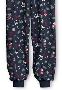 Navy pajama bottoms feature a holiday pattern with nutcracker soldiers, rocking horses, candy canes, and snowflakes in red and green accents.