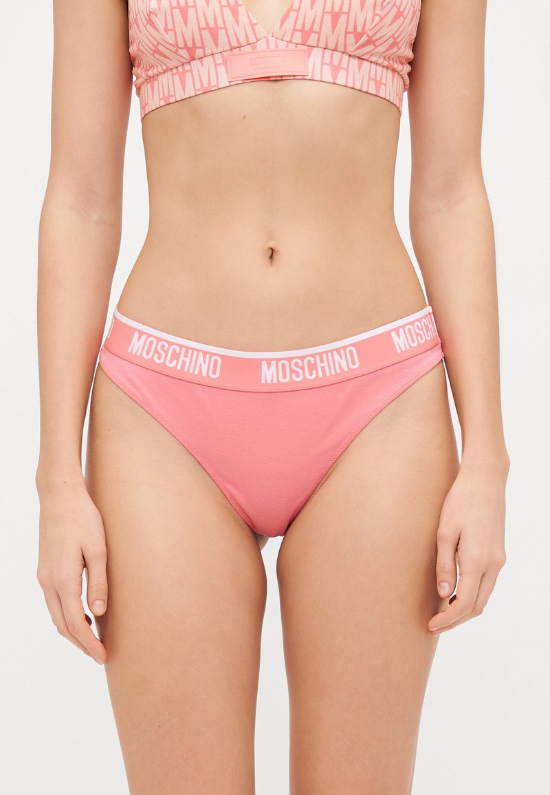 Pink cotton panties with a white Moschino logo waistband, featuring a simple design and smooth texture.