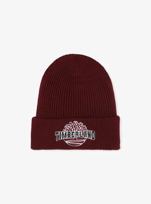 Bordeaux gebreide beanie met een omgeslagen manchette, voorzien van een wit geborduurd Timberland-logo en een ronde grafische detail. Zachte, ribbelige textuur.