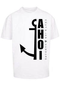 White cotton t-shirt featuring bold black text reading "AHOI" and an anchor graphic, with "Knut & Jan Hamburg" printed alongside.