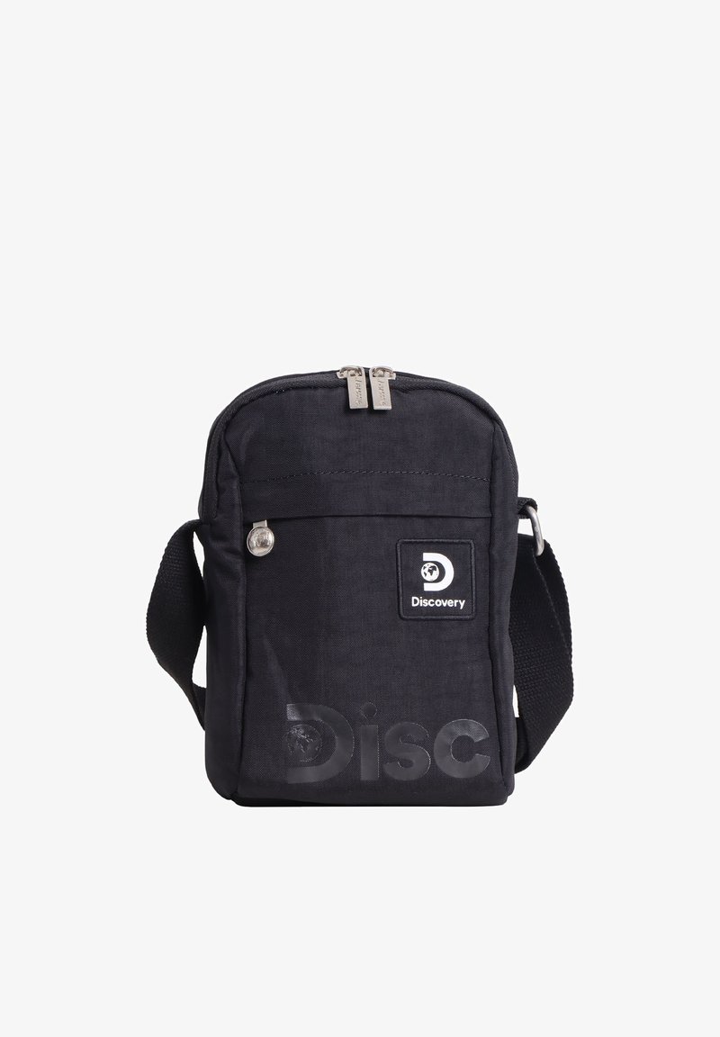 Schwarze kompakte Umhängetasche mit Reißverschluss-Hauptfach, Fronttasche, verstellbarem Riemen und „Discovery“-Logopatch auf der Vorderseite.
