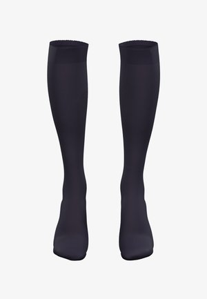Knästrumpor i mörk marinblå, slät textur, subtil lyster, vågig toppband, åtsittande design för komfort och formad fotsula.