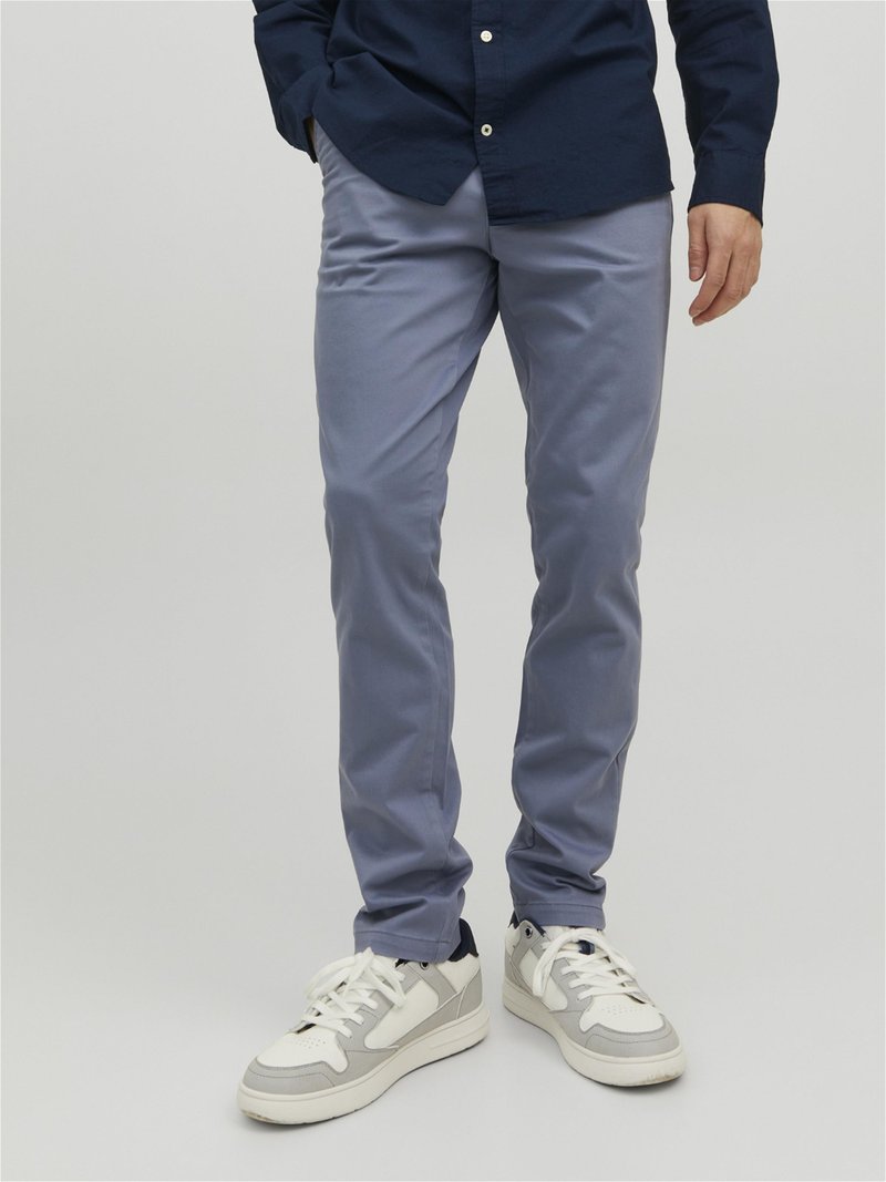 Helles blaues Slim-Fit-Hosen aus Baumwollmischung, mit einer glatten Textur und kombiniert mit weißen und grauen Sneakers.