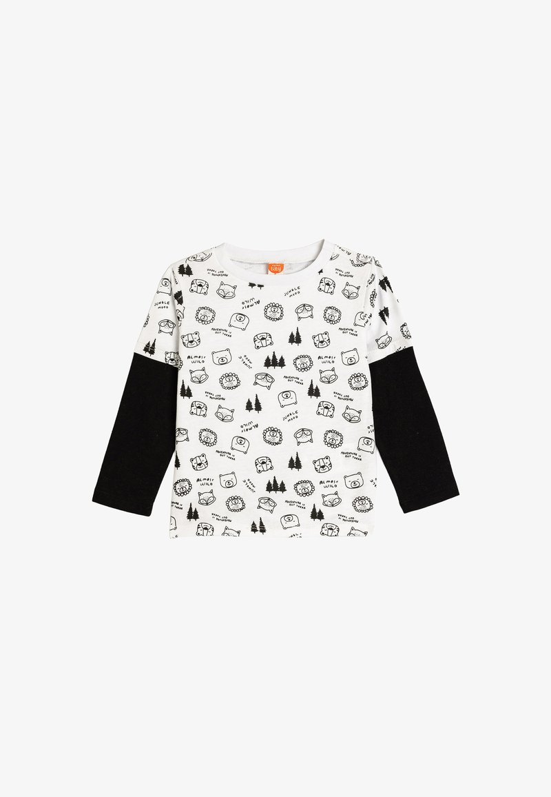 Long-sleeve shirt featuring a white fabric with black animal and tree prints, complemented by solid black sleeves. Round neckline.
