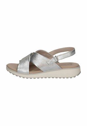 Sandales métalliques argentées avec des brides entrecroisées, une lanière de cheville réglable et une semelle plateforme beige clair. Texture lisse et design respirant.