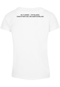 White short-sleeve t-shirt with black text on upper back: "Be a flamingo — Stay balanced, stand by your flock, and always be brilliant."