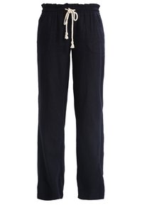 Navy blue linen pants with a relaxed fit, elastic waistband, and a drawstring with tassels. Features side pockets and a smooth texture.