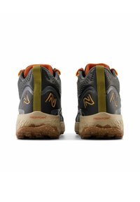 Dark gray hiking shoes featuring a textured upper, orange accents, a padded collar, and a light brown sole with a rugged tread pattern.