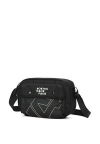 Borsa a tracolla nera realizzata in tessuto resistente, con un pattino anteriore con chiusure a scatto, un audace design grafico bianco e una tracolla regolabile.
