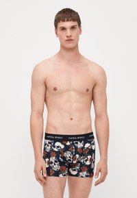 Boxershorts mit navyfarbenem Grund und einem Muster aus Schädeln und Rosen, elastischem Bund mit der Aufschrift "JACK & JONES", aus weichem Material, körpernahem Schnitt.