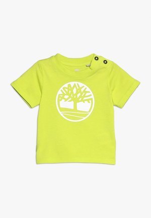 Felgele peuter-T-shirt met korte mouwen, twee drukknoopjes op de schouder en een wit cirkelvormig boomlogo op de borst.