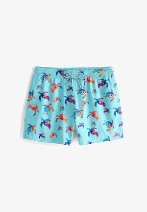 Svetlo modri kopalni hlače s pisanimi motivi želv. Narejene so iz lahkega materiala z elastičnim pasom in vrvico za prilagoditev.