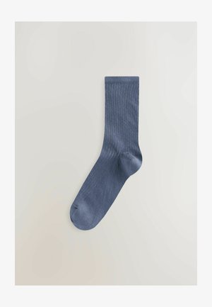 Navy blue ribbed sock made of soft, elastic material, featuring a seamless top and reinforced toe for added durability and comfort.