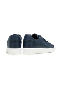 Sneaker in pelle blu navy con suola in gomma bianca, caratterizzati da un profilo basso, punta rotonda e design tradizionale con lacci. Texture liscia e linee pulite.