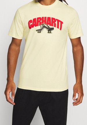 Koszulka bawełniana z krótkim rękawem w jasnym żółtym kolorze, z dużym czerwonym logo 'Carhartt' oraz grafiką czarno-białego projektu samochodu.