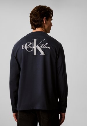 Calvin Klein Jeans, MONOLOGO GRAPHIC LONG SLEEVE T-SHIRT - Блуза с дълги ръкави - blue nights