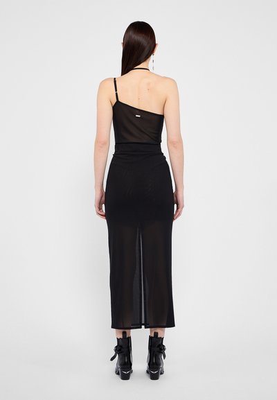 Black sheer dress featuring a one-shoulder design, slim fit, and a high slit at the back, accentuated by minimalist hardware.