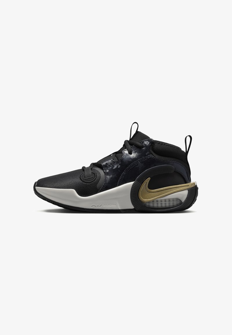 Black and grey athletic shoe with a textured upper, padded collar, and a gold Nike swoosh. The sole is white with a black rubber outsole and air unit.