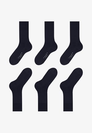 Tamno plavi dukserice s glatkom teksturom, s rebrastim rubom i suptilnim logotipom na dryžini, raspoređeni u šablonu mreže.
