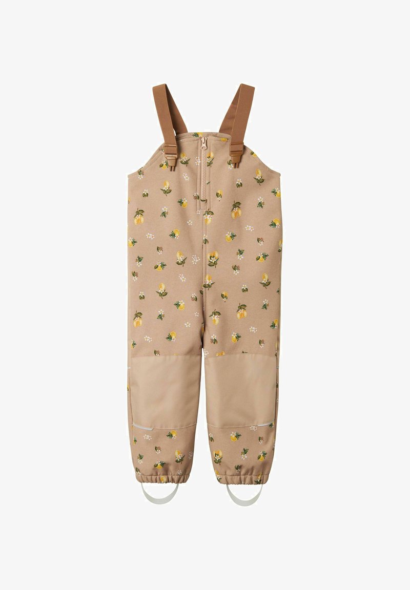 Salopette beige avec un imprimé de citrons jaunes et de fleurs, poignets élastiques, bretelles brunes ajustables, fermeture éclair à l'avant et deux grandes poches.