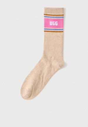 Beige geribbelde sok met een roze band aan de bovenkant, voorzien van witte "UGG" tekst en dunne bruine en blauwe strepen boven en onder de band.