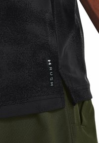 Black athletic shirt with "RUSH" label above olive green pants, showing side seam and pocket details on the clothing.