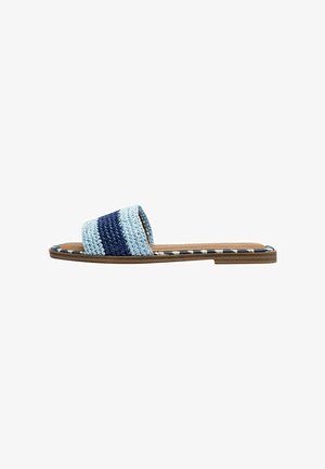 Woven slide sandal featuring a blue and light blue striped pattern, flat sole, and a soft leather footbed without embellishments.