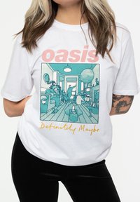 White cotton t-shirt featuring a teal graphic of people in a room, text reading "oasis" in pink and "Definitely Maybe" in yellow below.