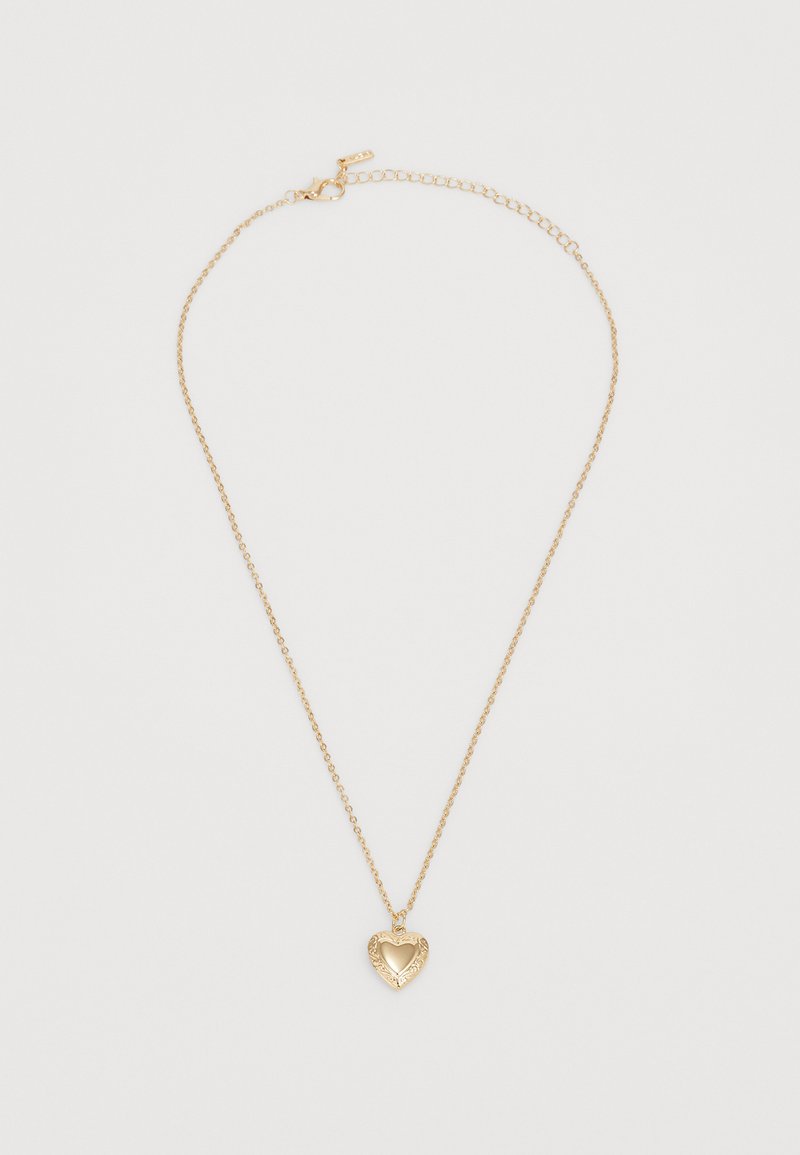 Gold necklace featuring a heart-shaped pendant with an ornate design and cutout center, suspended from a delicate chain with a clasp.