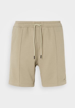Beige shorts made of textured fabric, featuring an elastic waistband with drawstring and two side seams. Simple design, no visible patterns.