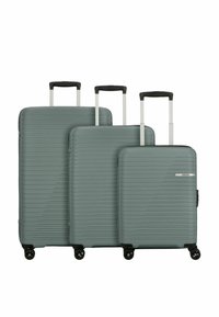 Trois valises rigides de couleur bleu sarcelle atténuée, présentant un design texturé à rainures, des poignées extensibles et chacune équipée de quatre roues pivotantes.