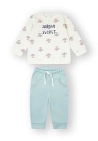 Conjunto de dos piezas para niños que incluye una sudadera crema con estampados de hongos rosas y texto "Jardin Secret", combinada con pantalones azul claro con cordón.