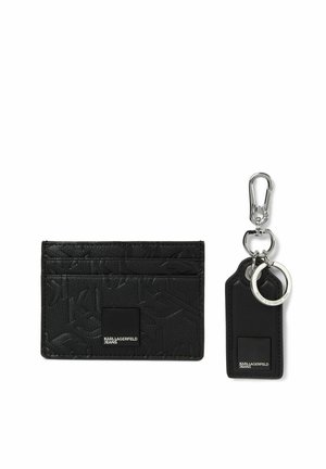 Portacarte nero Karl Lagerfeld Jeans con motivo logo in rilievo e portachiavi abbinato con chiusura e anello argentati su sfondo bianco.