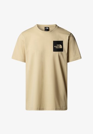Beige short-sleeve t-shirt made of cotton, featuring a black square logo on the left chest with white text. Crew neck design, plain texture.