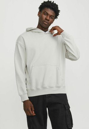 Light gray hooded sweatshirt with a front pocket, ribbed cuffs, and hem; worn over black cargo pants. Soft fabric texture is visible.