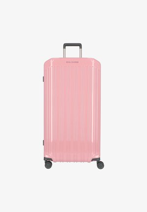 Valigia rigida rosa con scanalature verticali, manico telescopico, quattro ruote e finitura lucida per una facile mobilità.